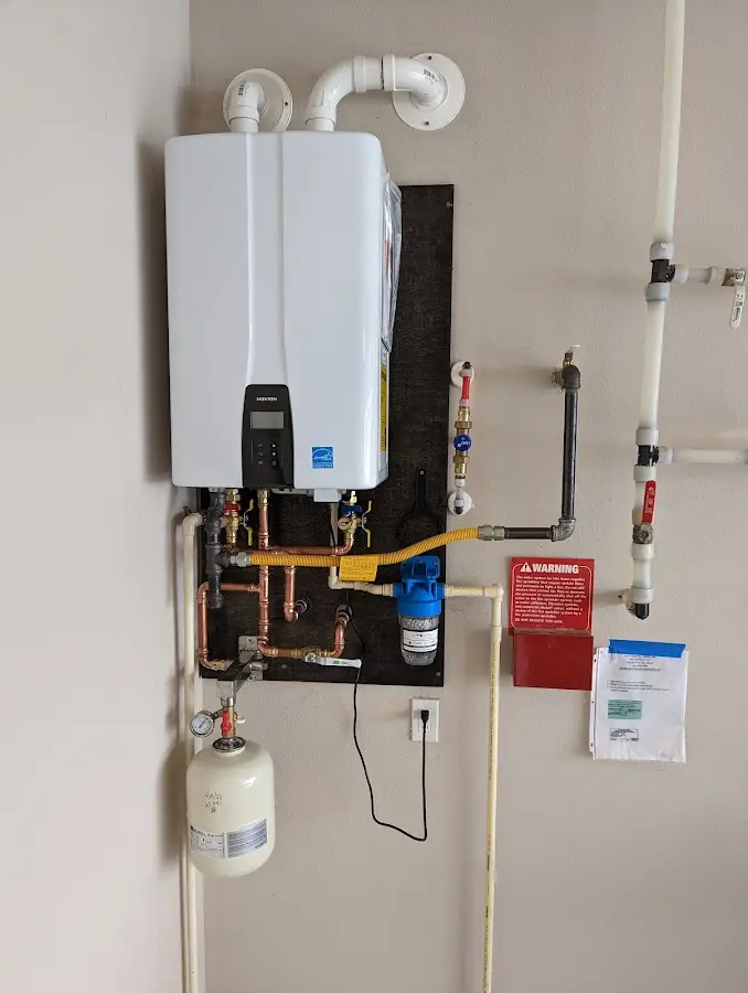 Professional plumber installing copper piping in a Troutdale home